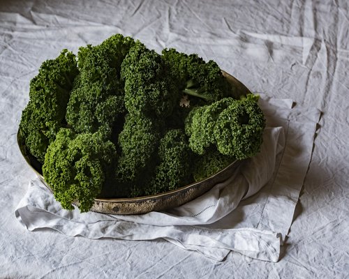 Fresh organic green kale and broccoli on table